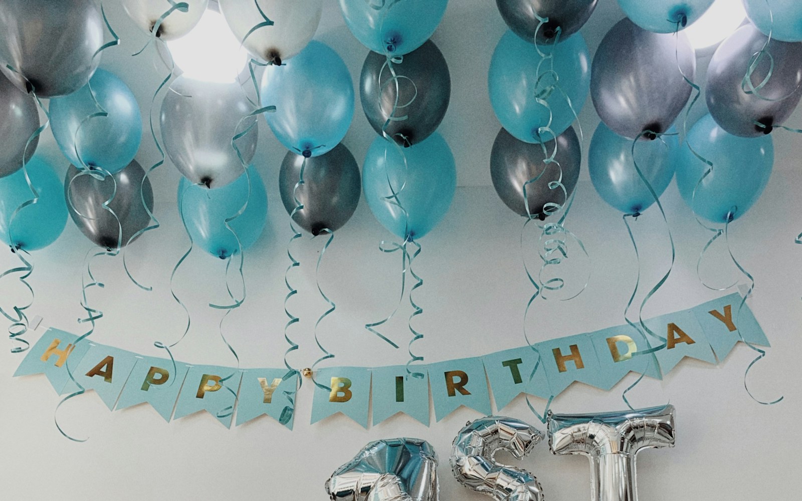 a table topped with balloons and a cake